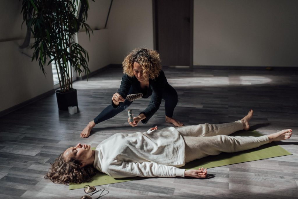 Woman engaging in a reiki healing session as a method of recovery from burnout.