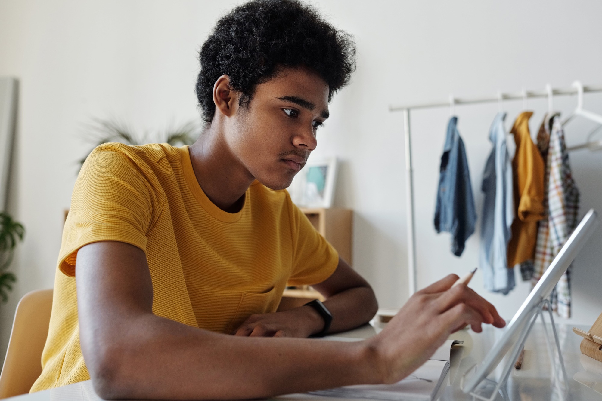 African American Teen using a laptop or tablet.