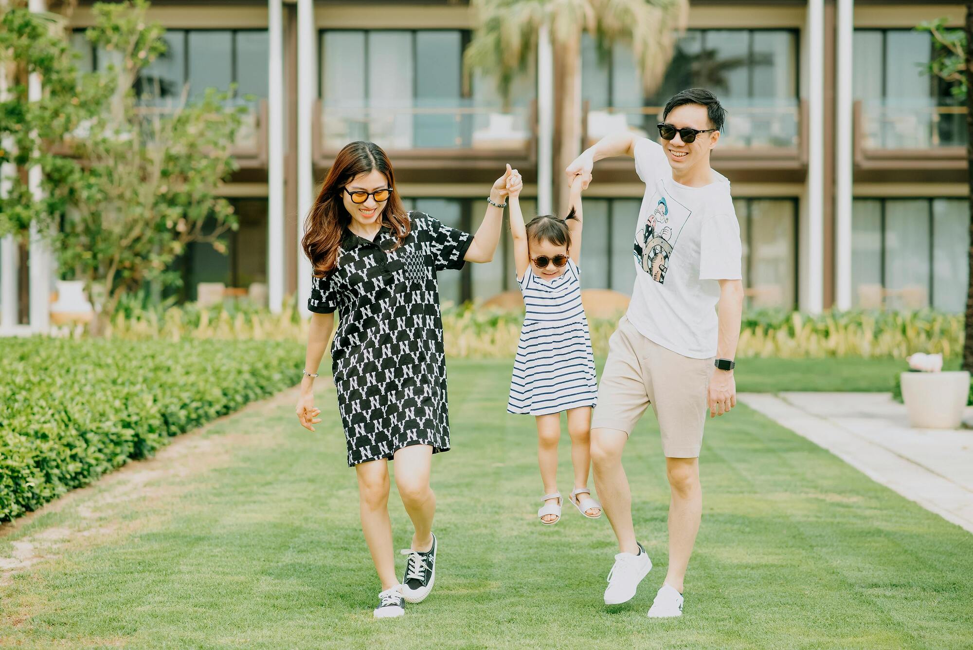 young parents and child wearing sunglasses